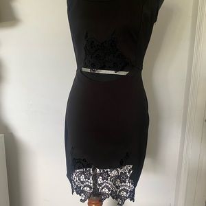 Black little dress with embroidery detailing on hem and waist.